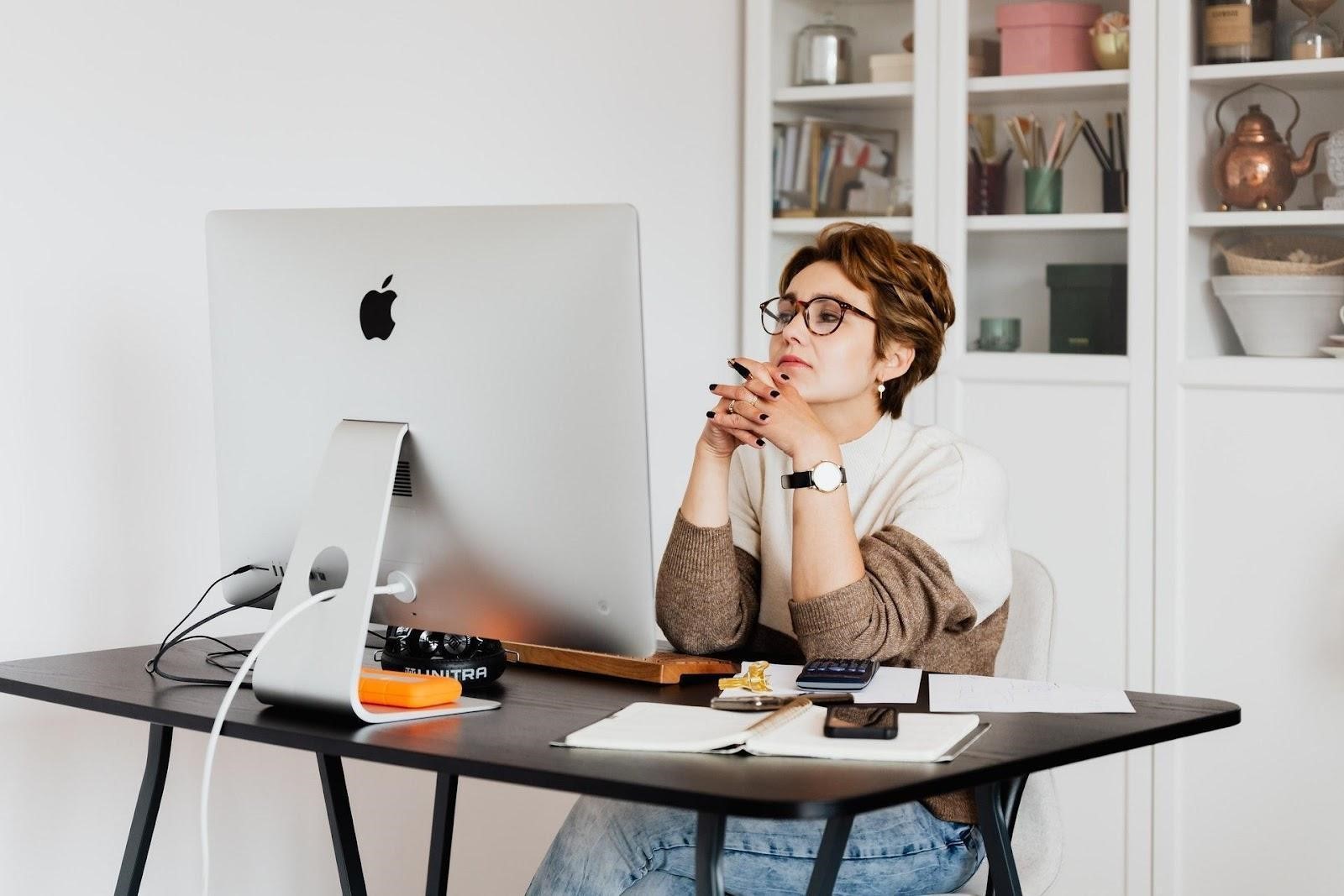 woman reading information on computer